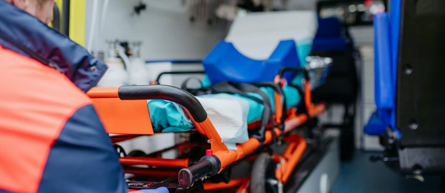 Close-up of empty stretcher inside ambulance vehicle.